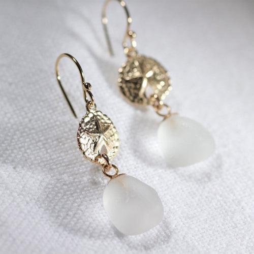 White Sea Glass Earrings in 14 kt gold-filled hanging from sand dollar charm