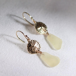 Yellow Sea Glass Earrings in 14 kt gold-filled hanging from sand dollar charm