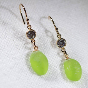 Lime Green Sea Glass Earrings in 14 kt gold-filled hanging from a sparkly bezel set CZ