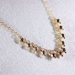 Gold bead charm necklace in 14 kt. GF
