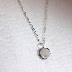 Diamond and silver Charm Necklace in sterling silver.