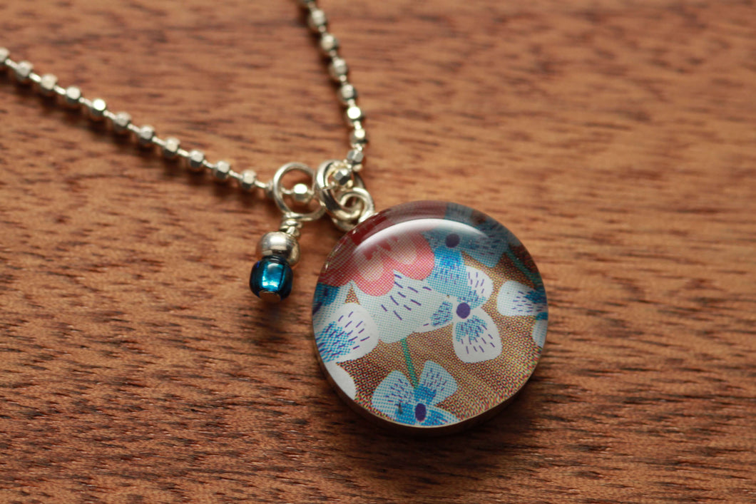 Forget-me-not necklace made from recycled Starbucks gift cards, sterling silver and resin