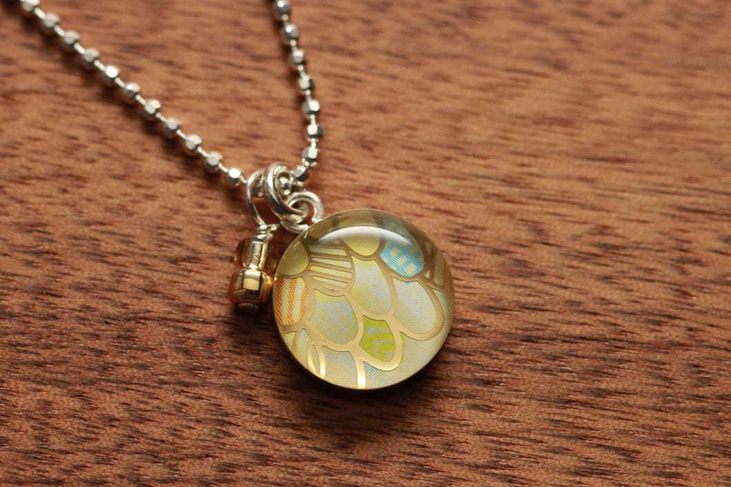 Golden Mermaid necklace made from recycled Starbucks gift cards, sterling silver and resin