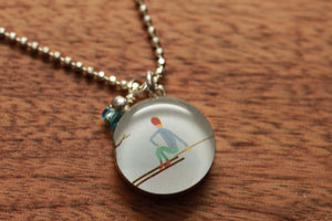 Skiing necklace made from recycled Starbucks gift cards, sterling silver and resin
