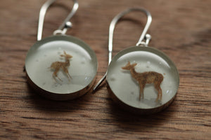 Deer in the snow earrings made from recycled Starbucks gift cards. sterling silver and resin