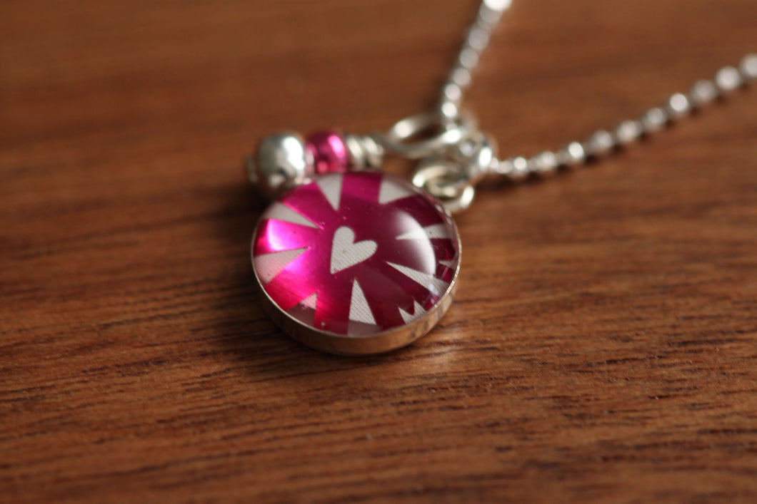 Tiny metallic pink heart necklace made from recycled Starbucks gift cards, sterling silver and resin