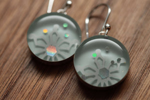 Snowflake sparkle earrings made from recycled Starbucks gift cards, sterling silver and resin